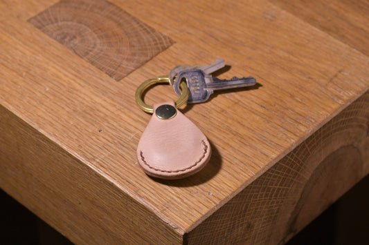 AirTag holder with brass keychain ring, natural veg tan leather, hand made (front shot with keys attached, full)