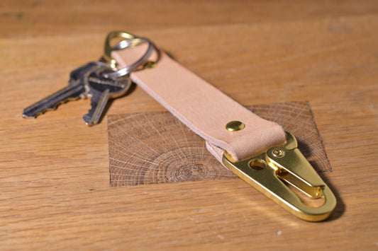 Keychain with carabiner style clip and brass hardware, natural veg tan leather, hand made (angle shot with keys, alt.)