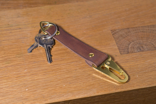 Keychain with carabiner style clip and brass hardware, brown veg tan leather, hand made (angle shot with keys, alt.)