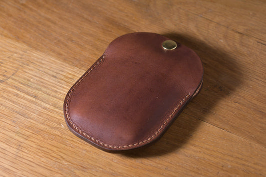 Minimal single pocket cash wallet with brass snap closure and pop open mechanism, brown veg tan leather, hand made (angle)