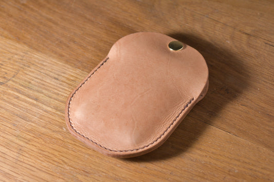 Minimal single pocket cash wallet with brass snap closure and pop open mechanism, natural veg tan leather, hand made (angle)