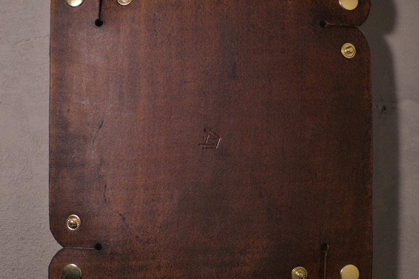 Folding Catchall with brass snaps, brown veg tan leather, hand made (unfolded/flat, back side with logo, close up)