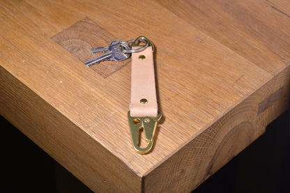 Keychain with carabiner style clip and brass hardware, natural veg tan leather, hand made (angle shot with keys)