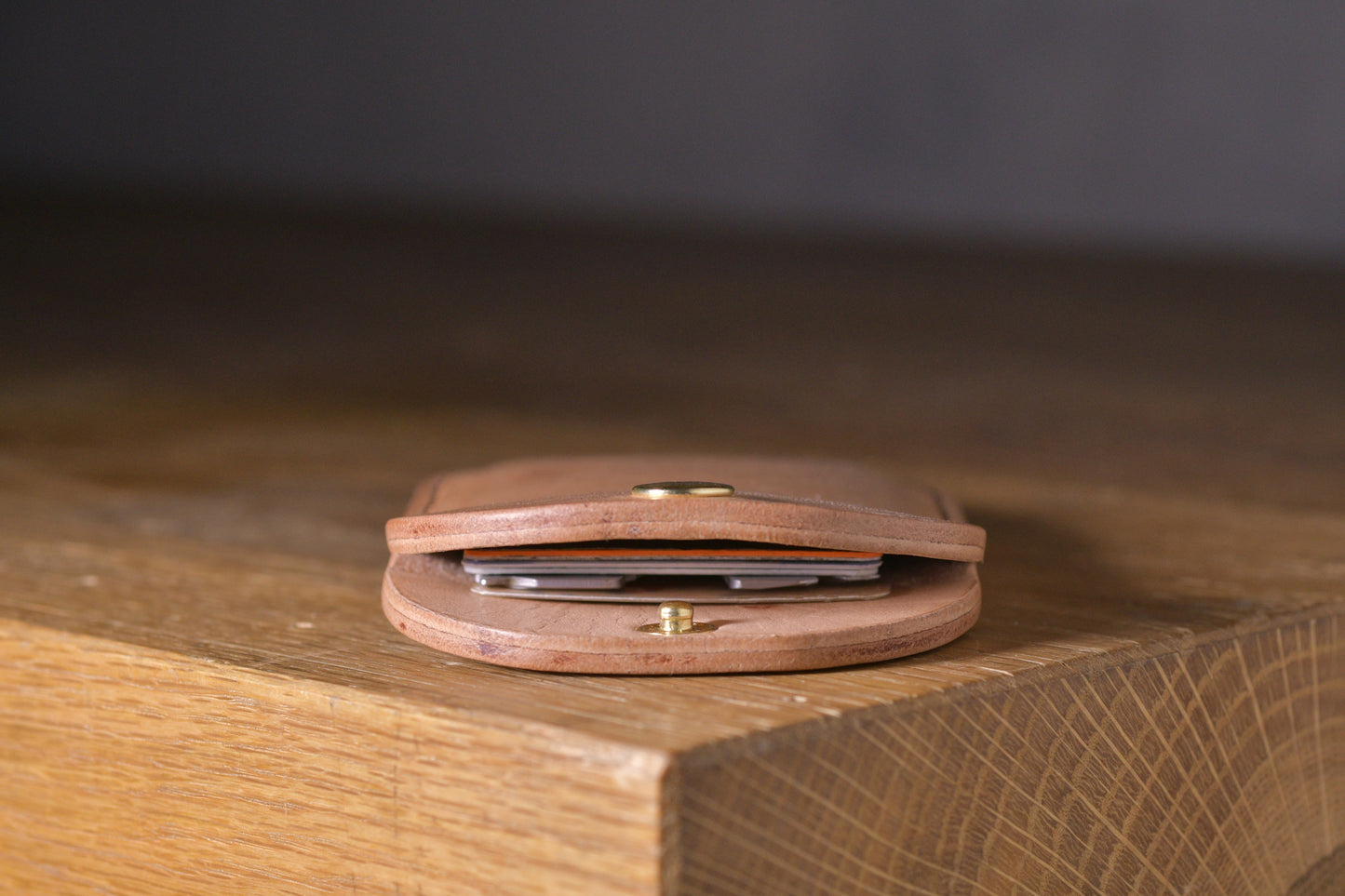 Minimal single pocket card wallet with brass snap closure and pop open mechanism, natural veg tan leather, hand made (inside)