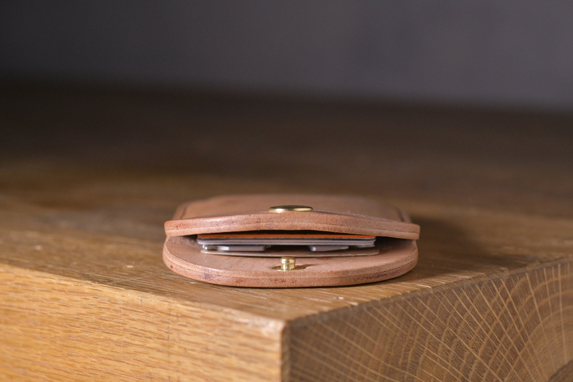 Minimal single pocket card wallet with brass snap closure and pop open mechanism, natural veg tan leather, hand made (inside)