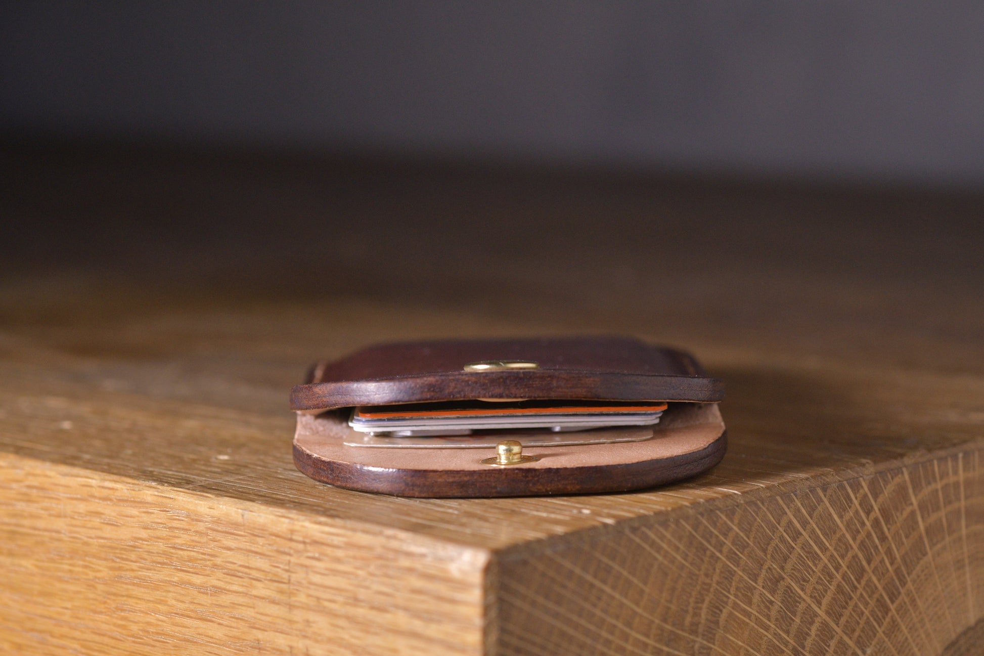 Minimal single pocket card wallet with brass snap closure and pop open mechanism, brown veg tan leather, hand made (inside)