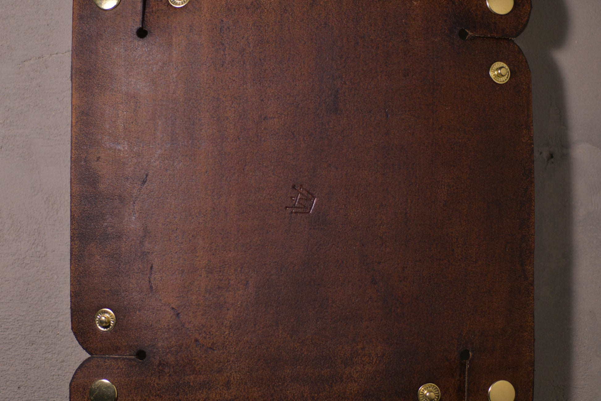 Folding Catchall with brass snaps, brown veg tan leather, hand made (unfolded/flat, back side with logo, close up)