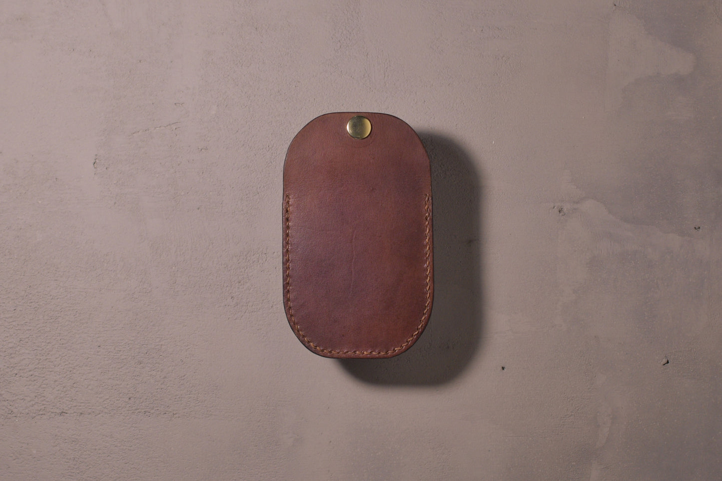 Minimal single pocket card wallet with brass snap closure and pop open mechanism, brown veg tan leather, hand made