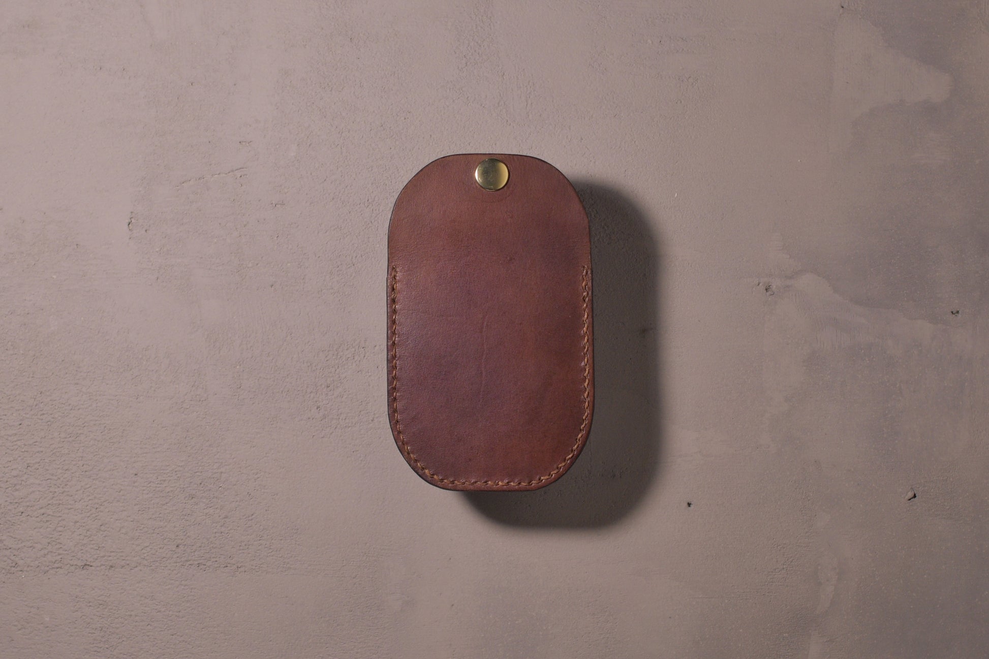 Minimal single pocket card wallet with brass snap closure and pop open mechanism, brown veg tan leather, hand made