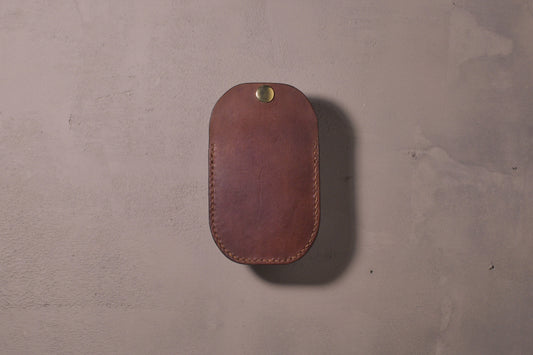 Minimal single pocket card wallet with brass snap closure and pop open mechanism, brown veg tan leather, hand made