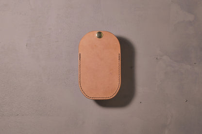Minimal single pocket card wallet with brass snap closure and pop open mechanism, natural veg tan leather, hand made