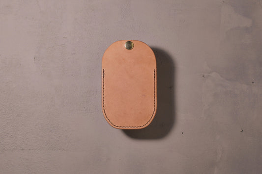Minimal single pocket card wallet with brass snap closure and pop open mechanism, natural veg tan leather, hand made