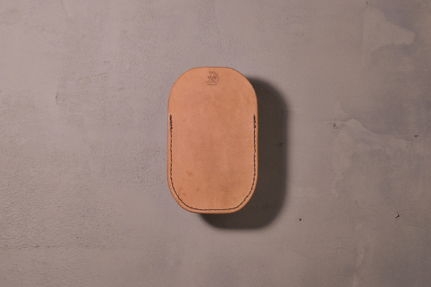 Minimal single pocket card wallet with brass snap closure and pop open mechanism, natural veg tan leather, hand made (back)