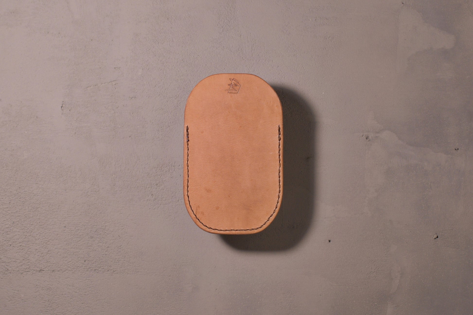 Minimal single pocket card wallet with brass snap closure and pop open mechanism, natural veg tan leather, hand made (back)