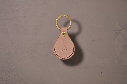 AirTag holder with brass keychain ring, natural veg tan leather, hand made (back side with logo)